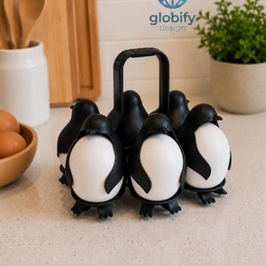May include: A black plastic egg cooker rack designed to hold six eggs, featuring a central handle and individual penguin-shaped holders that frame each egg. The rack includes the text globify design printed in blue above the egg holder unit.