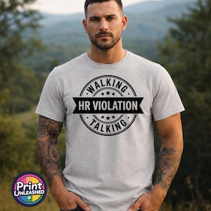 May include: A light grey short-sleeved t-shirt featuring a black circular graphic with the text WALKING and TALKING around the border and the words HR VIOLATION centred on a black horizontal banner across the middle of the circle.