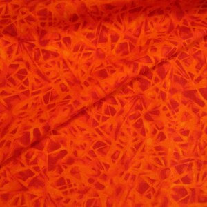 May include: Close-up of a fabric with a vibrant orange and red color scheme. The fabric features a complex pattern of interwoven lines, creating a textured and dynamic visual effect. The overall design suggests a fiery or energetic theme.