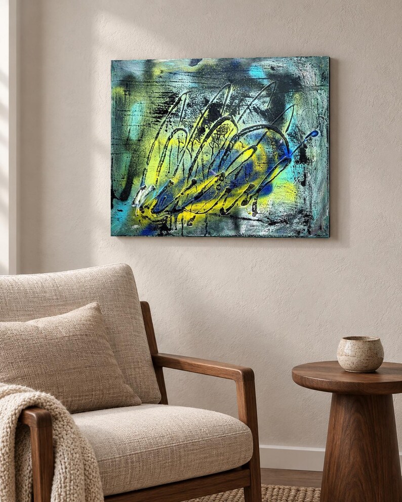 May include: A rectangular canvas painting featuring an abstract composition with vibrant yellow, bright cyan, and deep black paint. The artwork displays layered textures, energetic sweeping brushstrokes, and splattered paint effects across the surface.