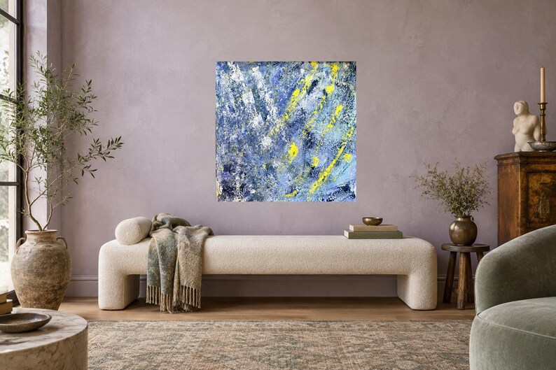 May include: A square canvas painting featuring an abstract composition of layered blue, white, and dark navy paint strokes with prominent, bright yellow vertical and diagonal accents applied in a textured, expressive, and thick impasto style.