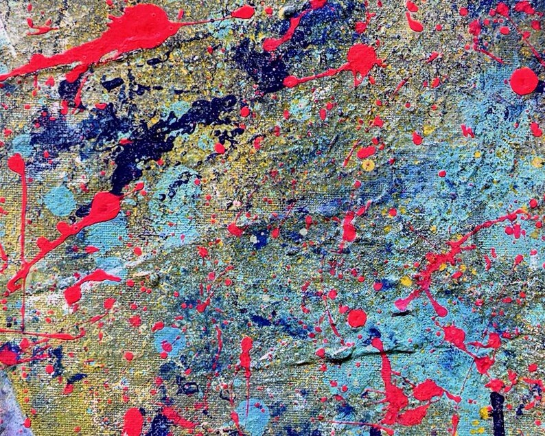 May include: A textured canvas painting featuring a vibrant abstract composition. The surface is layered with splatters and drips of bright neon pink paint over a base of deep navy blue, light turquoise, and metallic gold tones on a woven fabric.