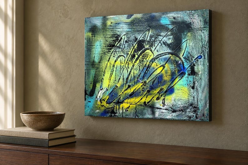 May include: A rectangular canvas painting featuring abstract layers of vibrant yellow, electric blue, and deep black paint. The composition displays energetic, sweeping brushstrokes and splattered textures that create a sense of movement across the surface.