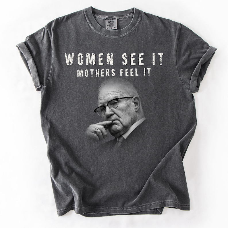 Unisex graphic T-shirt featuring a Kevin Reddington portrait with bold BEAST lettering and the phrase “Women see it. Mothers feel it.”