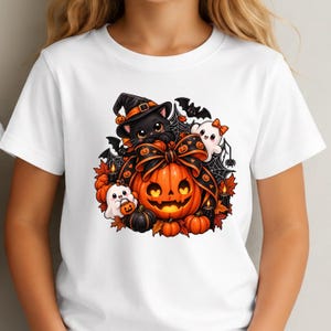 May include: A white t-shirt featuring a colorful Halloween graphic. The design includes a black cat wearing a witch hat, a large orange jack-o'-lantern with a black bow, two small white ghosts, bats, spiderwebs, and autumn leaves.