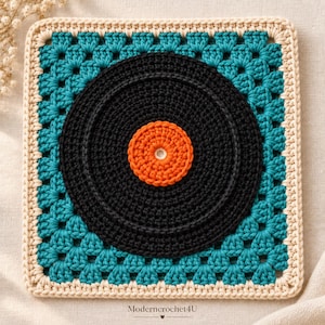 May include: A square crochet granny square featuring a central black vinyl record design with an orange center label. The record is surrounded by a teal blue crochet pattern and finished with a cream-colored border. The text Moderncrochet4U is visible.