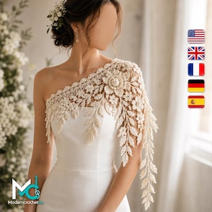 May include: A cream-colored, one-shoulder crochet lace overlay featuring intricate floral and leaf patterns, draped over a smooth, solid white sleeveless dress. The delicate lace design extends across the shoulder and down the arm.