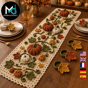 May include: A cream-colored crochet table runner featuring an intricate pattern of three-dimensional pumpkins in shades of orange and white, green leaves, and small flowers. The set includes matching crochet napkin rings with leaf motifs.