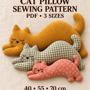 May include: A PDF sewing pattern for a cat pillow in 3 sizes: 40, 55, and 70 cm. The image displays three cat-shaped pillows: a large mustard yellow corduroy cat, a medium green and white gingham cat, and a small coral floral print cat.