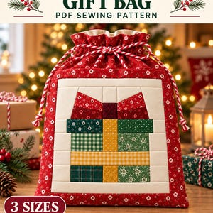 May include: A red drawstring gift bag featuring a quilted patchwork design of a wrapped present in the center. The bag has a red and white twisted cord closure and is labeled with the text DRAWSTRING GIFT BAG PDF SEWING PATTERN 3 SIZES.