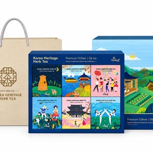 May include: A beige paper gift bag with silver handles and a blue gift box set containing six individual tea boxes. The boxes feature colorful illustrations of Korean cultural scenes, including traditional architecture, figures, and landscapes.