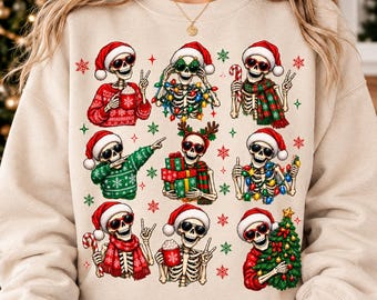 May include: A beige crewneck sweatshirt featuring a graphic print of nine skeletons wearing Santa hats and sunglasses. The skeletons are depicted in various festive poses, holding candy canes, Christmas gifts, mugs, and decorated with string lights.