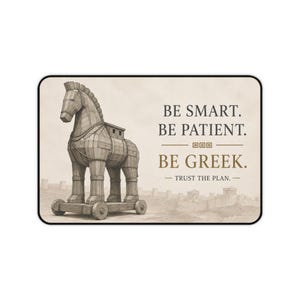 May include: A rectangular print featuring a wooden Trojan horse on wheels on the left side. The text on the right reads: BE SMART. BE PATIENT. BE GREEK. TRUST THE PLAN. The background is a light beige color with a faint outline of ancient buildings.