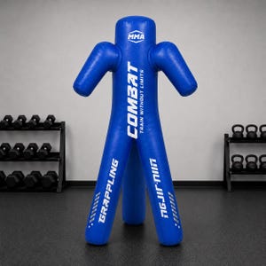 May include: A blue MMA grappling dummy featuring white text that reads COMBAT TRAIN WITHOUT LIMITS on the torso, with GRAPPLING and JIU-JITSU printed on the legs. The dummy has a humanoid shape with arms and legs designed for training.