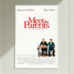 May include: A film poster for Meet the Parents starring Robert De Niro and Ben Stiller. The white poster features the red title, actor names, and an image of the two men at a table with a lie detector. It also includes production credits and text.