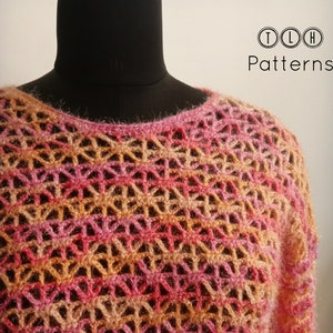 May include: A crocheted top with a lacy pattern in shades of pink, orange, and beige. The top is displayed on a mannequin.
