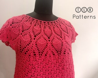 Puede incluir: Un top de ganchillo con un delicado patrón de encaje en un color rosa vibrante. El top tiene mangas cortas y un escote redondo. TLH Patterns está impreso en la esquina superior derecha de la imagen.
