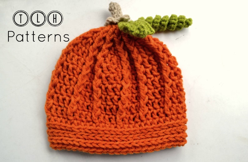 May include: Orange knitted pumpkin hat with a green crocheted stem. The hat has a cable knit pattern and is perfect for fall.