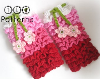 May include: A pair of crocheted leg warmers with a pink, red, and white ombre design. The leg warmers have a green crocheted ribbon and pink crocheted flowers with white buttons.