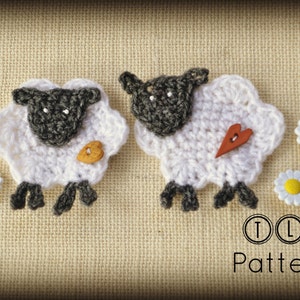 May include: Two handmade crochet sheep with white wool and gray faces, legs, and ears. One sheep has a wooden button, the other a wooden heart. Two daisy buttons and the text "TLH Patterns" are also visible.
