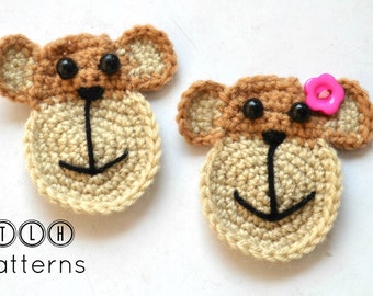 May include: Two crocheted monkey faces, one with a pink flower button. The monkey faces are brown and beige with black eyes and a black stitched mouth.
