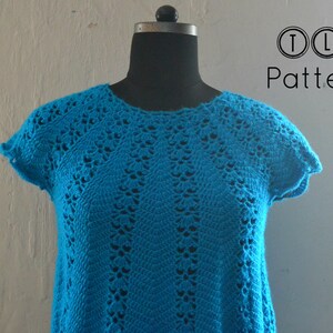 May include: A turquoise crochet top with a delicate openwork pattern. The top has short sleeves and a round neckline. TLH Patterns is printed on the background.