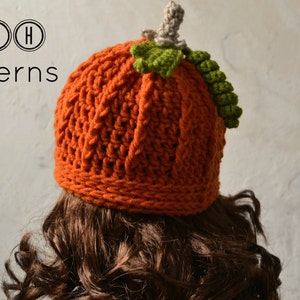 May include: A crocheted pumpkin hat in orange with a green stem and leaves. The hat is worn on a person with brown curly hair. The text "TLH Patterns" is visible in the top left corner of the image.