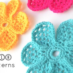 May include: Three crocheted flowers in yellow, pink, and turquoise. The flowers are all the same size and shape, and they have a simple, delicate design. The flowers are arranged in a row on a white background. The text "TLH Patterns" is below the flowers.