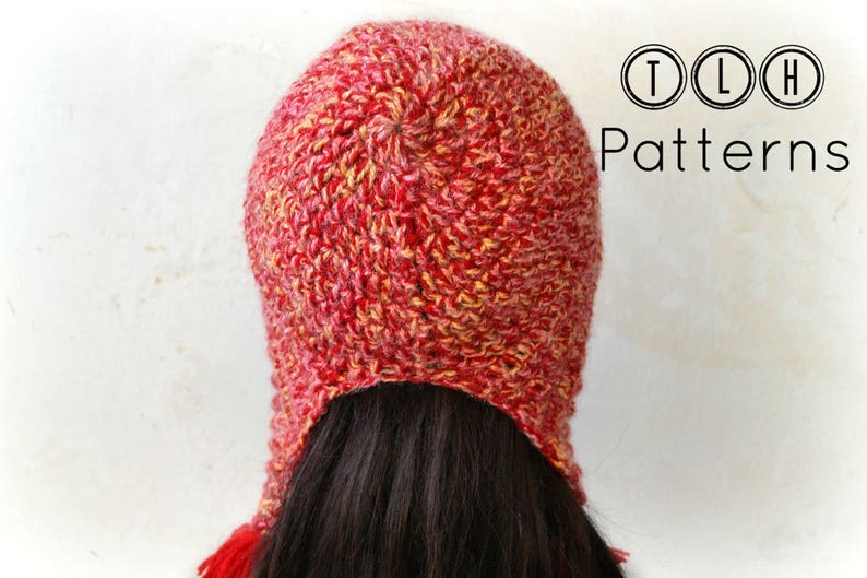 May include: Red and yellow crocheted hat with a long tail. The hat is made with a textured stitch and has a slouchy fit.