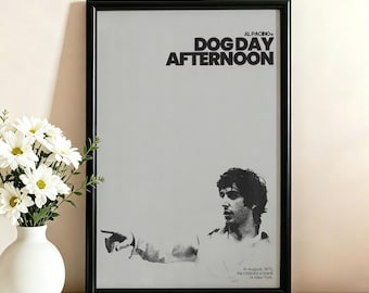 May include: A framed movie poster for Dog Day Afternoon featuring a black and white illustration of Al Pacino pointing. The text reads AL PACINO in DOG DAY AFTERNOON and In August, 1972, He robbed a bank in New York. The poster has a light gray background.