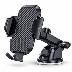 May include: A black car phone mount featuring an adjustable cradle with a carbon fibre textured back panel, side gripping arms, and a bottom support shelf. The mount includes a telescoping arm and a circular suction cup base for attachment.