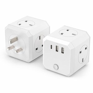 May include: Two white cube-shaped power adapters featuring multiple electrical outlets and USB ports. Each device includes a three-pin plug on one side, several standard three-pin sockets on the faces, and a circular power button on the front panel.