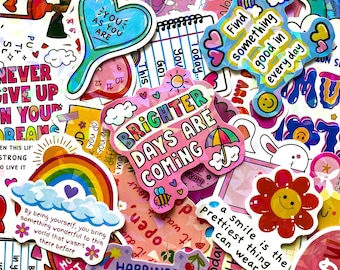 May include: A collection of colourful vinyl stickers featuring various motivational quotes and illustrations including rainbows, flowers, hearts, and clouds. The designs incorporate text such as Brighter days are coming, Find something good in everyday, and You as you are.