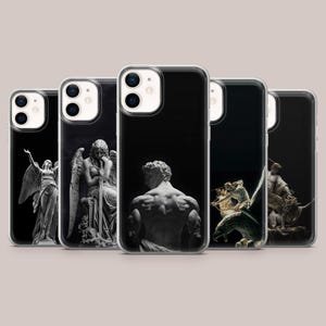 May include: Five clear smartphone cases arranged in a row, each featuring a distinct black and white photographic print of classical marble statues. The designs include winged figures, a seated person with a sword, a muscular back, and mythological scenes.