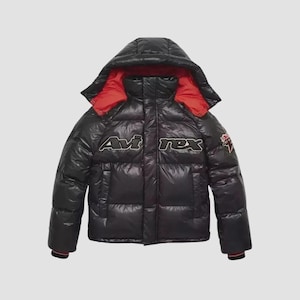 May include: A black puffer jacket with a glossy finish, featuring a hood with a bright red interior lining. The word Avi-rex is embroidered in white across the chest, and a small red and white star patch is visible on the left sleeve cuff.