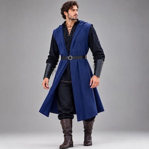 May include: A sleeveless blue hooded vest worn over a black long-sleeved shirt with a lace-up neckline. The outfit includes black trousers, a black belt with a silver buckle, black forearm bracers with lacing, and brown leather mid-calf boots.