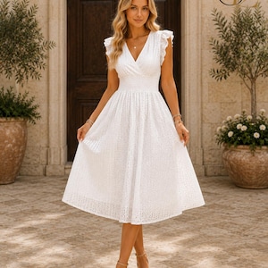May include: A white midi dress featuring a V-neckline, flutter sleeves, and a smocked waist. The fabric is crafted with an intricate eyelet lace pattern throughout, extending to a full, flared skirt that falls below the knees in a classic silhouette.