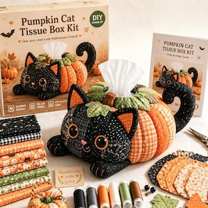 May include: A DIY sewing kit for a pumpkin cat tissue box, including a cardboard box with product imagery, a step-by-step guide, stacks of patterned fabric, spools of thread, and a finished plush pumpkin cat tissue box cover.
