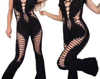 May include: A black jumpsuit with a V-neck and short sleeves. The jumpsuit features a lace-up design on the bodice and cut-out detailing along the sides of the legs. The pants have a flared bottom.