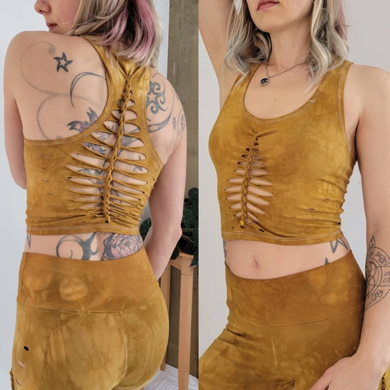 May include: A mustard yellow crop top with a unique braided design on the back. The top is made of a soft, comfortable fabric and has a relaxed fit.
