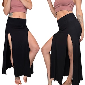 May include: Black maxi skirt with two high slits on the sides. The skirt is made of a soft, stretchy fabric.