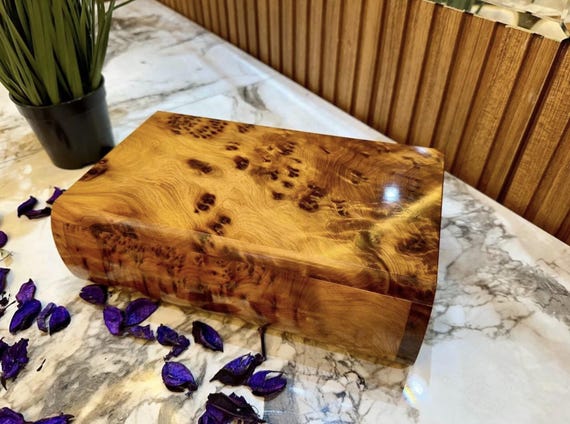 Handcrafted from rare Thuya burl wood — that wild, swirling grain makes every box a one-of-a-kind object you'd never find at a department store.
