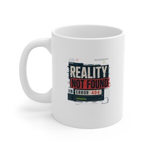May include: A white ceramic mug featuring a graphic design with the text REALITY NOT FOUND and ERROR 404 in black and red. The design includes digital glitch elements, a loading bar, and technical symbols arranged in a rectangular block format.