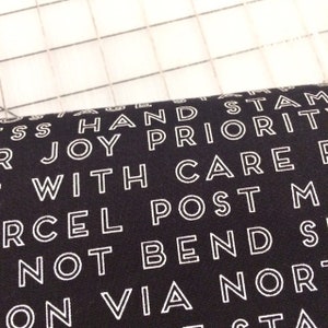 Riley Blake - Christmas Delivery - Text in Black - Continuous yardage available, sold by the half yard