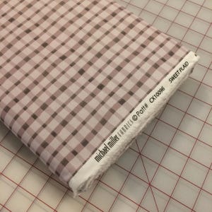 May include: A pink and brown gingham fabric with the text "michael miller fabrics @Patt# CX10096 SWEET PLAID" on the edge.