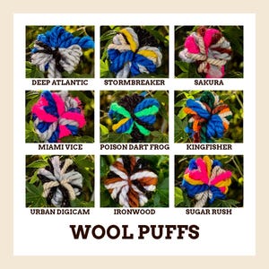 May include: A grid of nine wool puffs in various color combinations labeled Deep Atlantic, Stormbreaker, Sakura, Miami Vice, Poison Dart Frog, Kingfisher, Urban Digicam, Ironwood, and Sugar Rush, with the text WOOL PUFFS centered at the bottom.