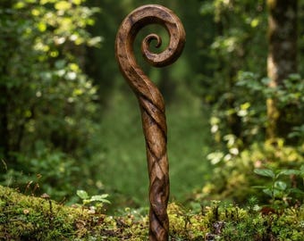 May include: A hand-carved wooden staff featuring a dark brown finish with a prominent spiral design at the top. The shaft of the staff displays a twisted, textured grain pattern that runs vertically along the length of the wood, showcasing natural wood tones.
