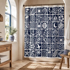 May include: A white shower curtain featuring a grid of dark blue squares, each containing a unique white icon. The icons include marine life like fish, jellyfish, crabs, and starfish, alongside coastal elements such as shells, waves, and anchors.