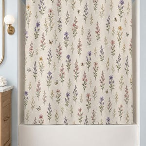May include: A shower curtain featuring an off-white background with a repeating pattern of vertical wildflower stems in shades of purple, pink, and yellow, interspersed with small illustrations of butterflies and bees hanging from a gold rod.