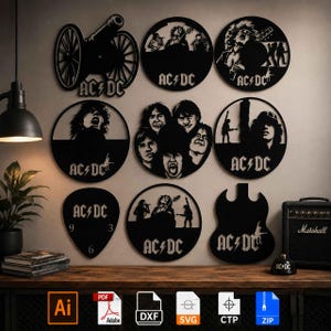 May include: A collection of black metal wall art pieces featuring AC/DC band imagery, including circular designs with silhouettes of band members, a cannon, a guitar pick shape, and a guitar silhouette, all displaying the AC/DC logo text.